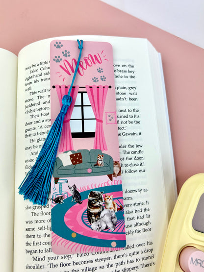 Bookmark with turquoise tassel and images of cats, light pink base